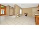 Bright living room featuring neutral walls, white tile floors, and a double-door closet at 713 Dorado Ct, Brandon, FL 33511