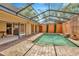 Relaxing screened pool area featuring brick pavers, lush landscaping, and access to the main home at 713 Dorado Ct, Brandon, FL 33511