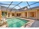 Inviting screened pool surrounded by brick pavers with access to the home's interior through multiple sliding doors at 713 Dorado Ct, Brandon, FL 33511
