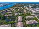 Aerial view of the townhouse community with a pond, beautiful landscaping, and manicured lawns at 728 Seagate Dr, Tampa, FL 33602