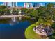 Beautiful aerial view of the community pond surrounded by lush landscaping and views of downtown buildings at 728 Seagate Dr, Tampa, FL 33602