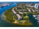 Stunning aerial view of waterfront condos with a pool and lush landscaping, plus views of the bay at 728 Seagate Dr, Tampa, FL 33602