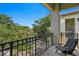 Relaxing condo balcony features a lounge chair, scenic lake view, and lots of mature green trees at 728 Seagate Dr, Tampa, FL 33602