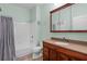 Well-maintained bathroom with a shower-tub combo, wood vanity, and tile floor at 728 Seagate Dr, Tampa, FL 33602
