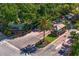 Aerial view of a gated community entrance with lush landscaping, guard house, and mature palm trees at 728 Seagate Dr, Tampa, FL 33602