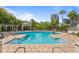 The community pool is surrounded by lush landscaping and comfortable lounge chairs and a gazebo at 728 Seagate Dr, Tampa, FL 33602