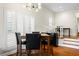 Modern dining space featuring large shuttered windows and dark wood furniture at 728 Seagate Dr, Tampa, FL 33602