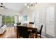 Dining area featuring modern chandelier, dark wood furniture and shuttered windows at 728 Seagate Dr, Tampa, FL 33602