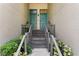 Inviting condominium entrance with dual teal doors, stone steps, and well-maintained landscaping at 728 Seagate Dr, Tampa, FL 33602