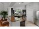 Well lit kitchen showcasing granite countertops, stainless steel appliances, and dark wood cabinets at 728 Seagate Dr, Tampa, FL 33602