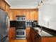 Well-lit kitchen features wood cabinets, granite countertops, and stainless steel appliances at 728 Seagate Dr, Tampa, FL 33602