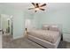 Light-filled main bedroom with neutral tones, a ceiling fan, and en-suite bathroom at 728 Seagate Dr, Tampa, FL 33602