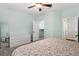 This spacious main bedroom features light green walls, a ceiling fan, and a door to a walk-in closet at 728 Seagate Dr, Tampa, FL 33602