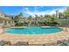Beautiful community pool with lounge chairs, lush landscaping and inviting pristine blue water at 728 Seagate Dr, Tampa, FL 33602