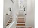 Bright stairway features beautiful wood treads, white risers, handrail, and landing at 728 Seagate Dr, Tampa, FL 33602