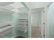 Organized walk-in closet with multiple shelves, drawers, and ample storage space at 728 Seagate Dr, Tampa, FL 33602