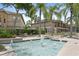 Apartment community fountain surrounded by tropical trees, creating a serene outdoor space at 728 Seagate Dr, Tampa, FL 33602