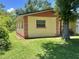 Side view of single-Gathering home featuring a well-maintained lawn and mature trees at 772 71St N Ave, St Petersburg, FL 33702