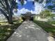 Charming home with a long driveway, covered porch, and well-maintained landscaping at 772 71St N Ave, St Petersburg, FL 33702