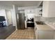 Modern kitchen featuring stainless steel appliances, tiled backsplash, and granite countertops at 772 71St N Ave, St Petersburg, FL 33702