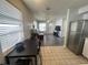 Modern kitchen seamlessly connected to living room with stainless steel refrigerator and dining area at 772 71St N Ave, St Petersburg, FL 33702