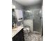 Modern bathroom featuring marble tile shower, safety bars and updated vanity and countertop at 9117 41St N Way # 5, Pinellas Park, FL 33782