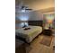 Comfortable bedroom with a ceiling fan, warm lighting, and a plush quilt on the bed at 9117 41St N Way # 5, Pinellas Park, FL 33782