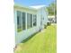 Exterior shot of the property highlighting the manicured lawn and white exterior with large windows for natural light at 9117 41St N Way # 5, Pinellas Park, FL 33782