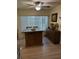 Charming eat-in kitchen featuring an island with granite countertops and storage, complemented by a ceiling fan and natural light at 9117 41St N Way # 5, Pinellas Park, FL 33782