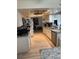 Bright kitchen featuring stainless steel appliances, granite countertops, and white cabinets, creating a modern and functional space at 9117 41St N Way # 5, Pinellas Park, FL 33782