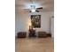 Cozy living room with light wood floors, decorative furniture, and a framed painting at 9117 41St N Way # 5, Pinellas Park, FL 33782