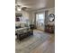 Bright living room with wood floors, comfortable seating, and large window, offering a welcoming and relaxing space at 9117 41St N Way # 5, Pinellas Park, FL 33782