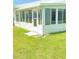 Enclosed patio with multiple windows offering serene views of the lush green lawn, ideal for indoor-outdoor living at 9117 41St N Way # 5, Pinellas Park, FL 33782