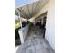 Inviting covered patio area featuring tiled flooring and comfortable seating, perfect for outdoor relaxation and entertainment at 9117 41St N Way # 5, Pinellas Park, FL 33782