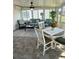 Bright sunroom with tile flooring, comfortable seating, and abundant natural light at 9117 41St N Way # 5, Pinellas Park, FL 33782