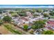 Aerial view of a neighborhood with tree lined streets, single Gathering homes, and lush landscapes at 9201 Spy Glass Ct, Tampa, FL 33615
