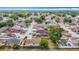 Aerial view featuring the neighborhood's homes with green spaces and tree-lined streets under a partly cloudy sky at 9201 Spy Glass Ct, Tampa, FL 33615