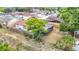 Aerial view showcasing a private fenced backyard with mature tree, screen enclosed lanai, and grassy surroundings at 9201 Spy Glass Ct, Tampa, FL 33615