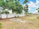 Large backyard showcasing the new white vinyl fence, mature trees, and lush landscaping at 9201 Spy Glass Ct, Tampa, FL 33615