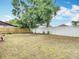 Large backyard featuring mature shade trees, lawn and white vinyl fence at 9201 Spy Glass Ct, Tampa, FL 33615