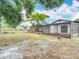 Backyard view showing the large lawn, mature trees, and screened-in patio at 9201 Spy Glass Ct, Tampa, FL 33615