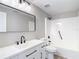 Modern bathroom featuring a black framed mirror, black fixtures, a white vanity and shower at 9201 Spy Glass Ct, Tampa, FL 33615