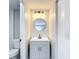 Bathroom featuring a modern vanity with a round mirror and contemporary lighting at 9201 Spy Glass Ct, Tampa, FL 33615