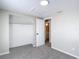 This bedroom has neutral walls, carpet, a modern ceiling light, closet, door to bath at 9201 Spy Glass Ct, Tampa, FL 33615
