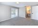 Bright bedroom featuring neutral paint, carpet, and sliding glass doors to a patio at 9201 Spy Glass Ct, Tampa, FL 33615