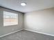 This bedroom features neutral walls, carpet, window, and a modern ceiling light at 9201 Spy Glass Ct, Tampa, FL 33615