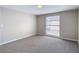 Neutral bedroom with carpet, and a window providing natural light at 9201 Spy Glass Ct, Tampa, FL 33615