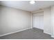 This bedroom has neutral walls, carpet, a modern ceiling light and a closet at 9201 Spy Glass Ct, Tampa, FL 33615