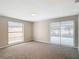 Spacious bedroom with neutral paint, carpet, and ample natural light from two windows at 9201 Spy Glass Ct, Tampa, FL 33615