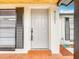 Up close front door with updated hardware, house number, and newly painted exterior at 9201 Spy Glass Ct, Tampa, FL 33615